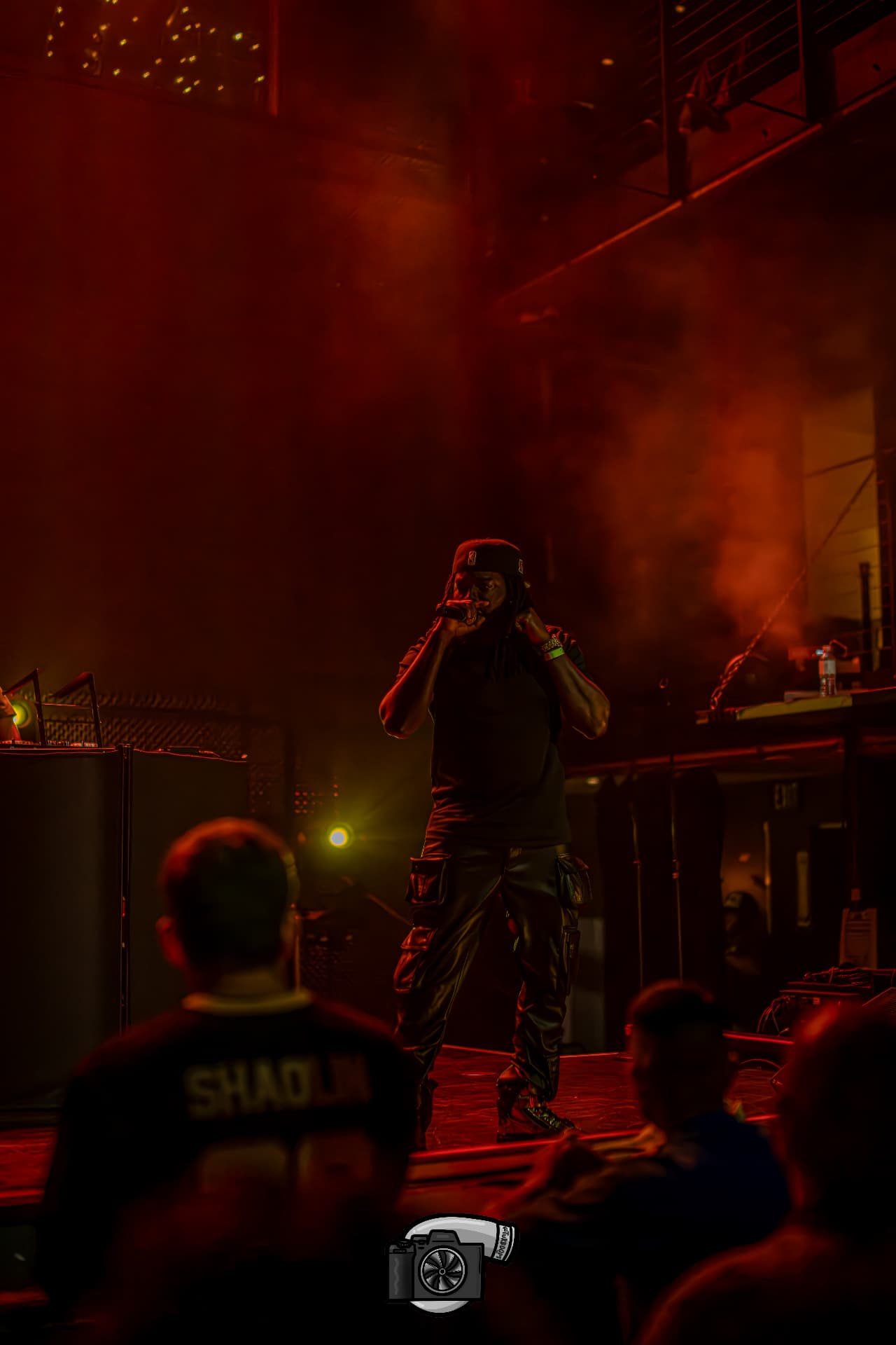 JoethePoet performing beneath red stage lights